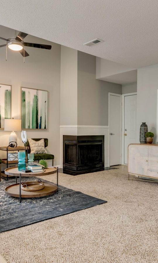 the living room has a fireplace and a large television at The  Quinn on Ravenglass
